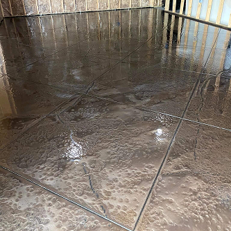 Reflective metallic epoxy floor with tile design installed by Epoxy Pros in a residential space